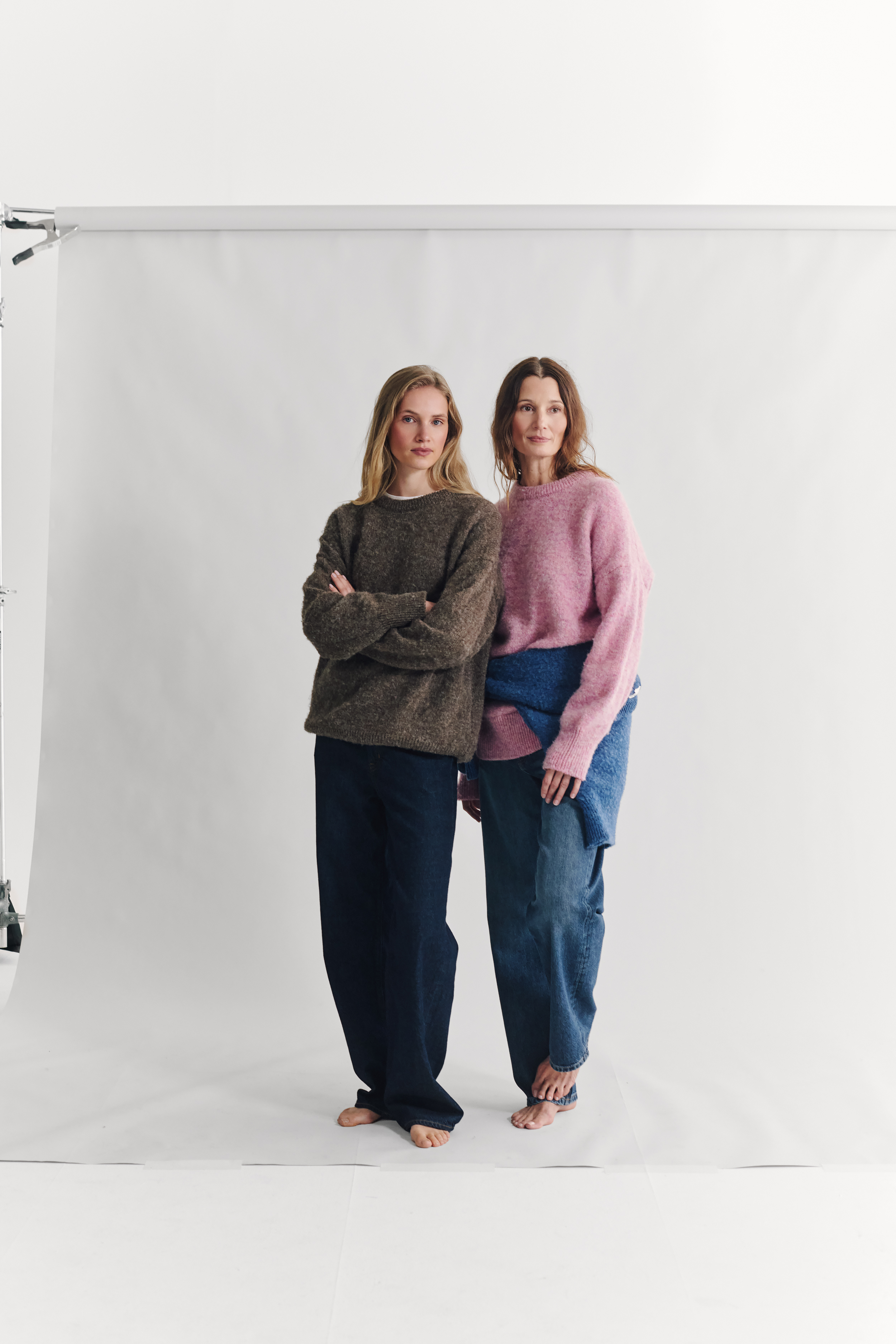 two models wearing navygrey knitted jumpers