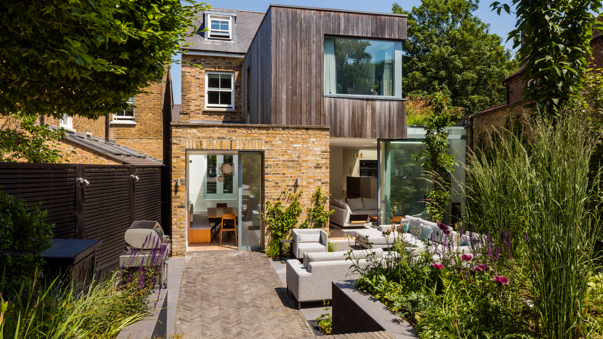 single brick extension and two storey extension with timber cladding