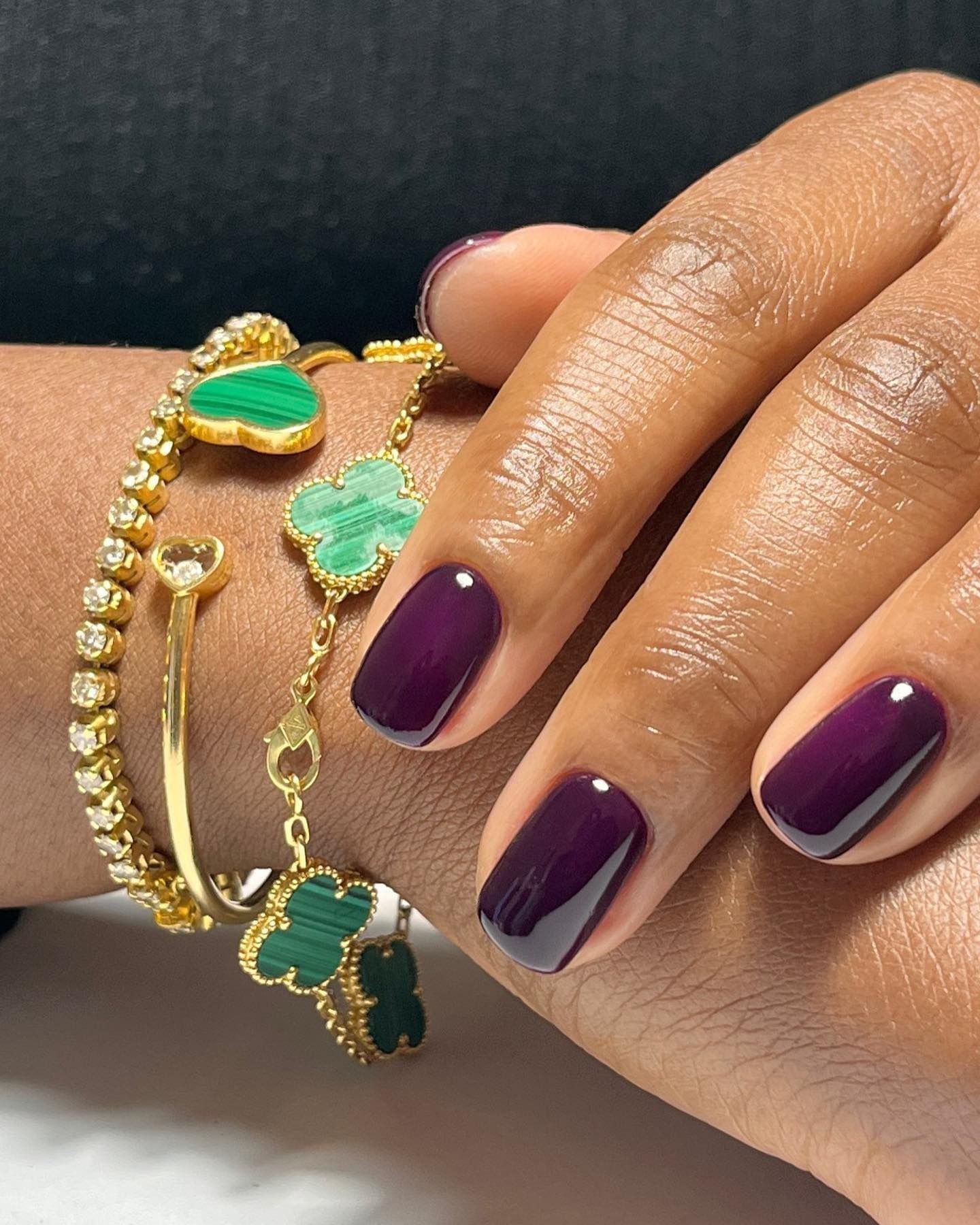 A short, square aubergine manicure