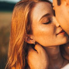 A man and woman kissing as she worries about quiet quitting relationships