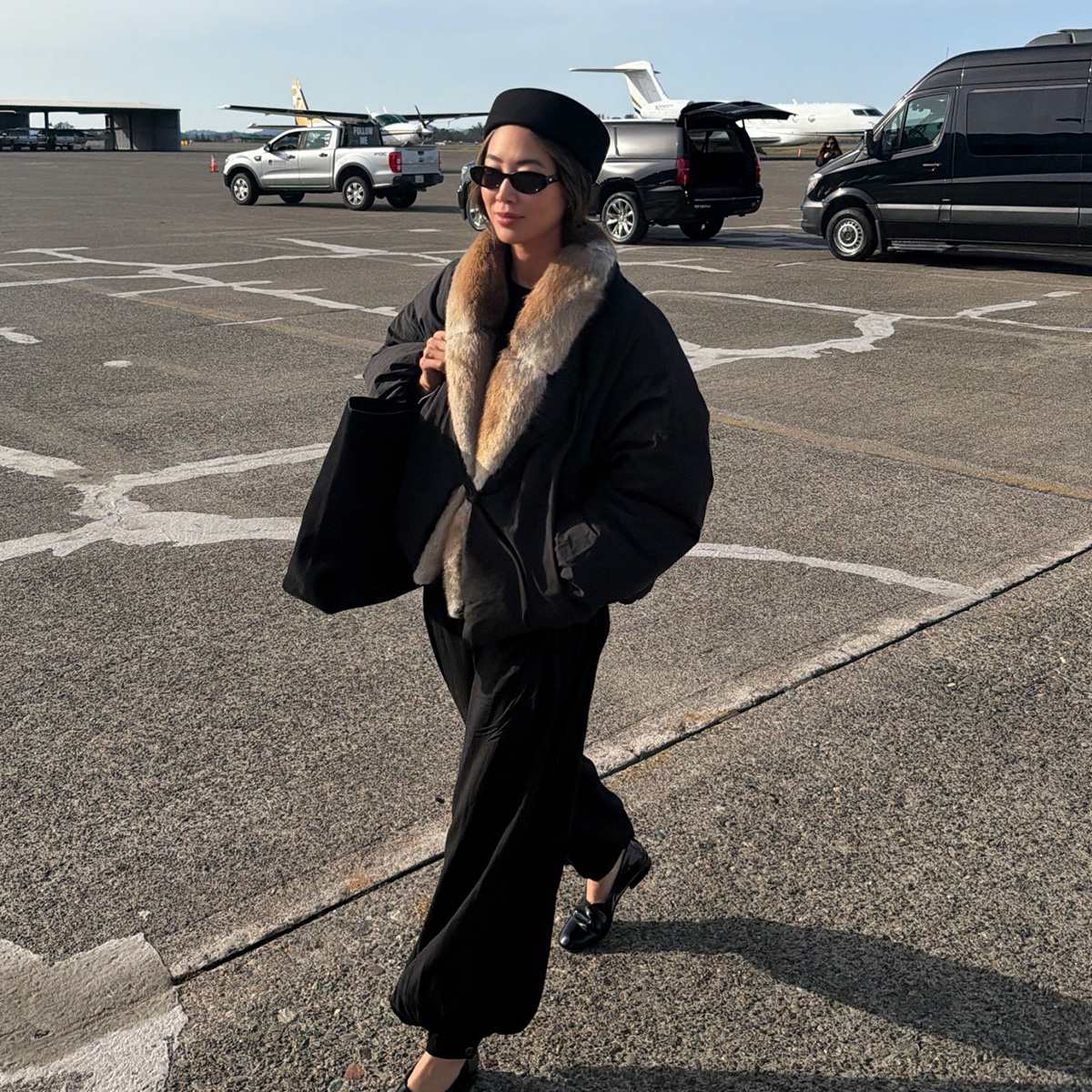 aimee song wearing a fur trim coat while traveling