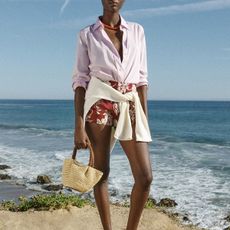 J.Crew model in classic button down shirt and printed shorts on the beach 