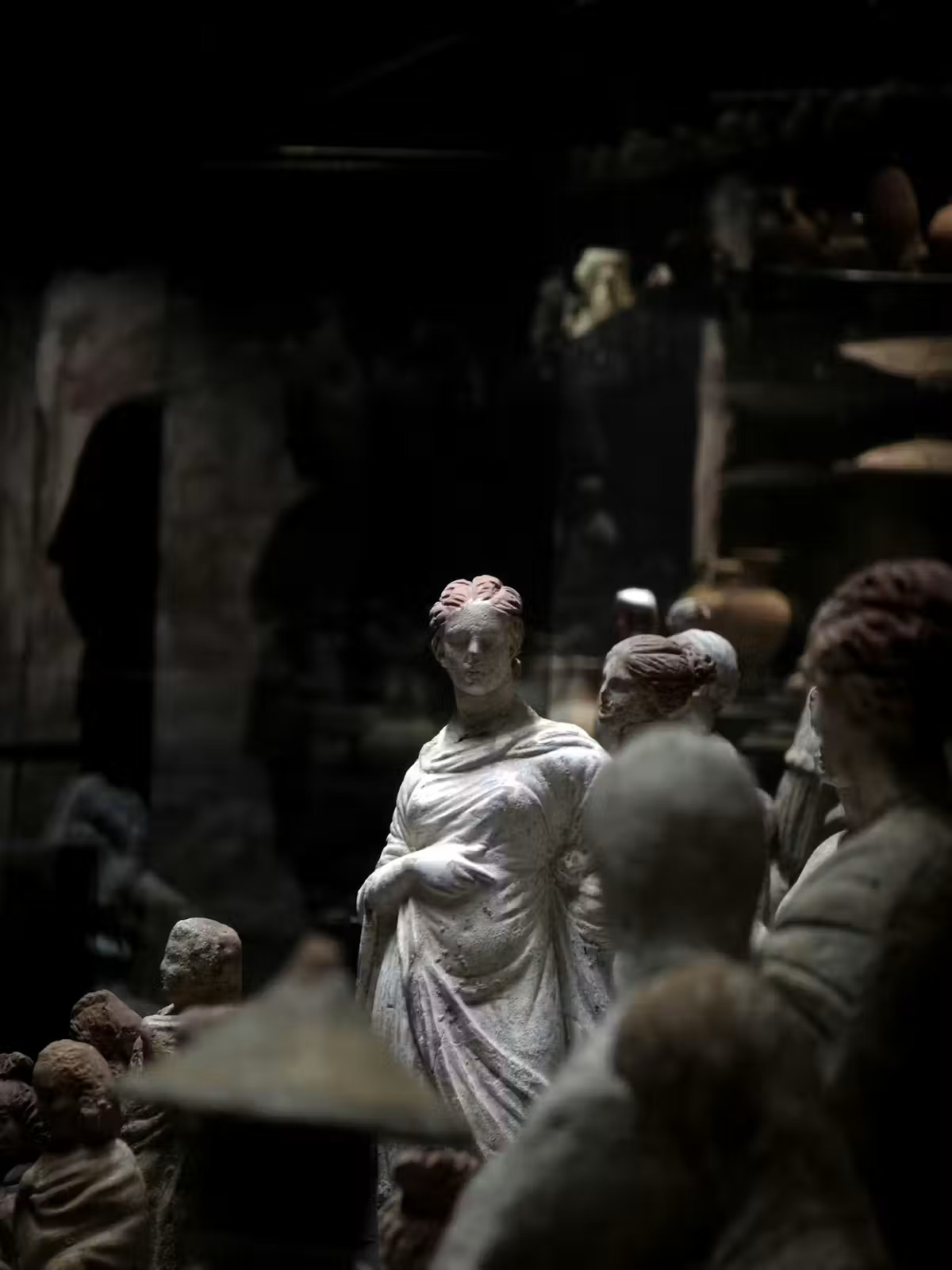A statue of a woman in a toga with other scientists