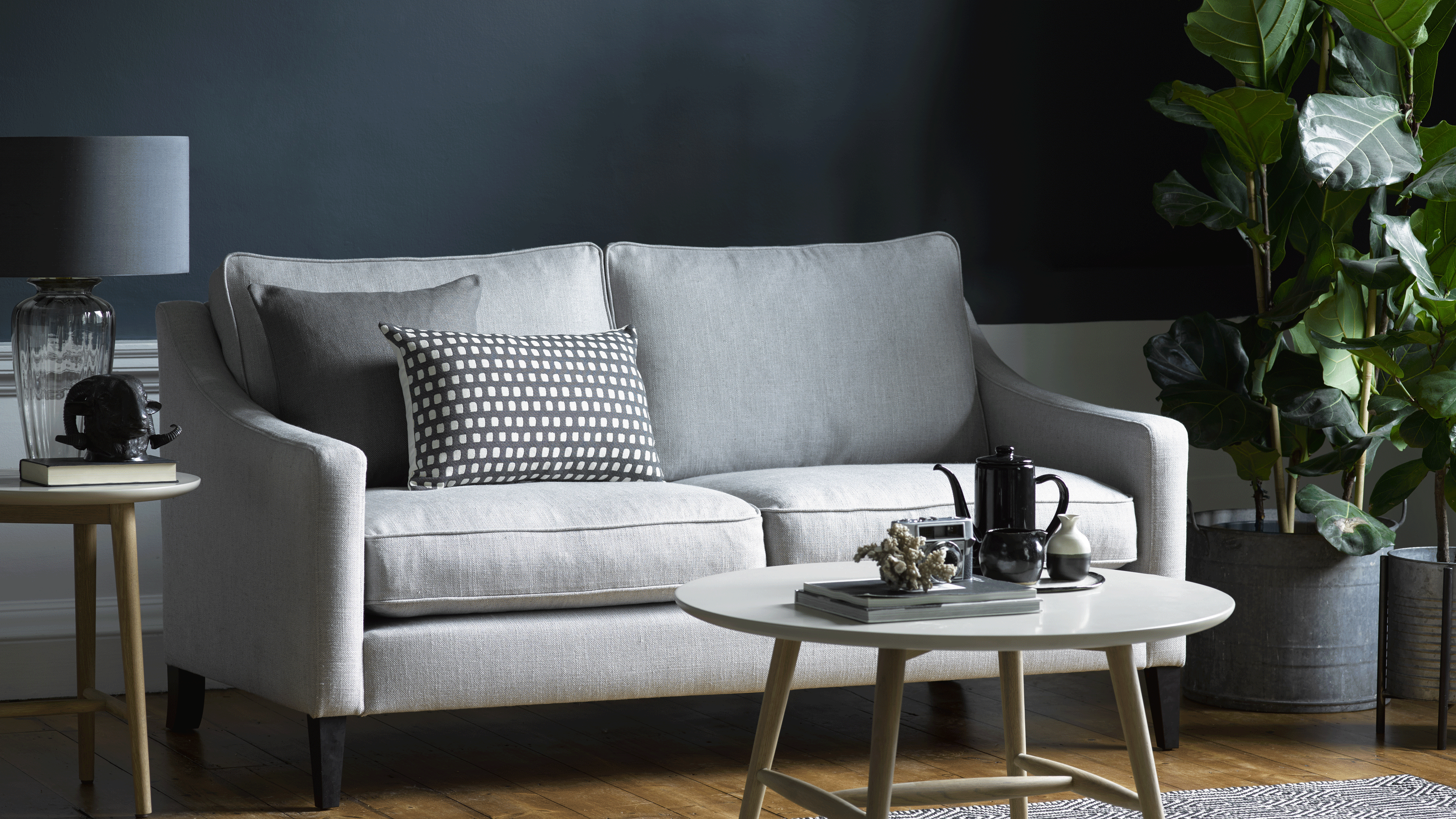 Grey sofa with coffee table and pillows