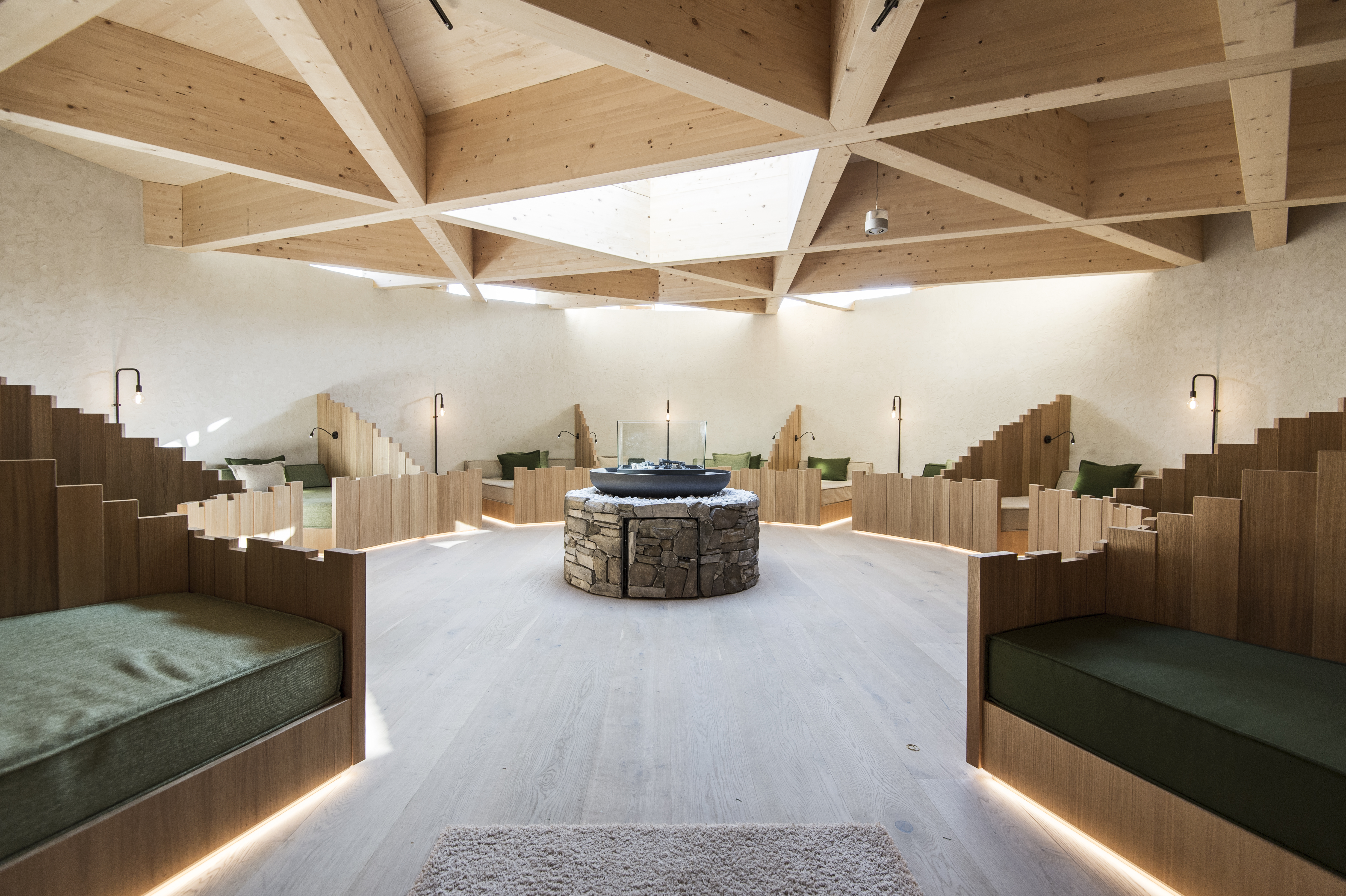 A design-forward mountain escape's sleek, minimalist design in wood, cement, and stone contrasts with the wilderness of its outdoors.