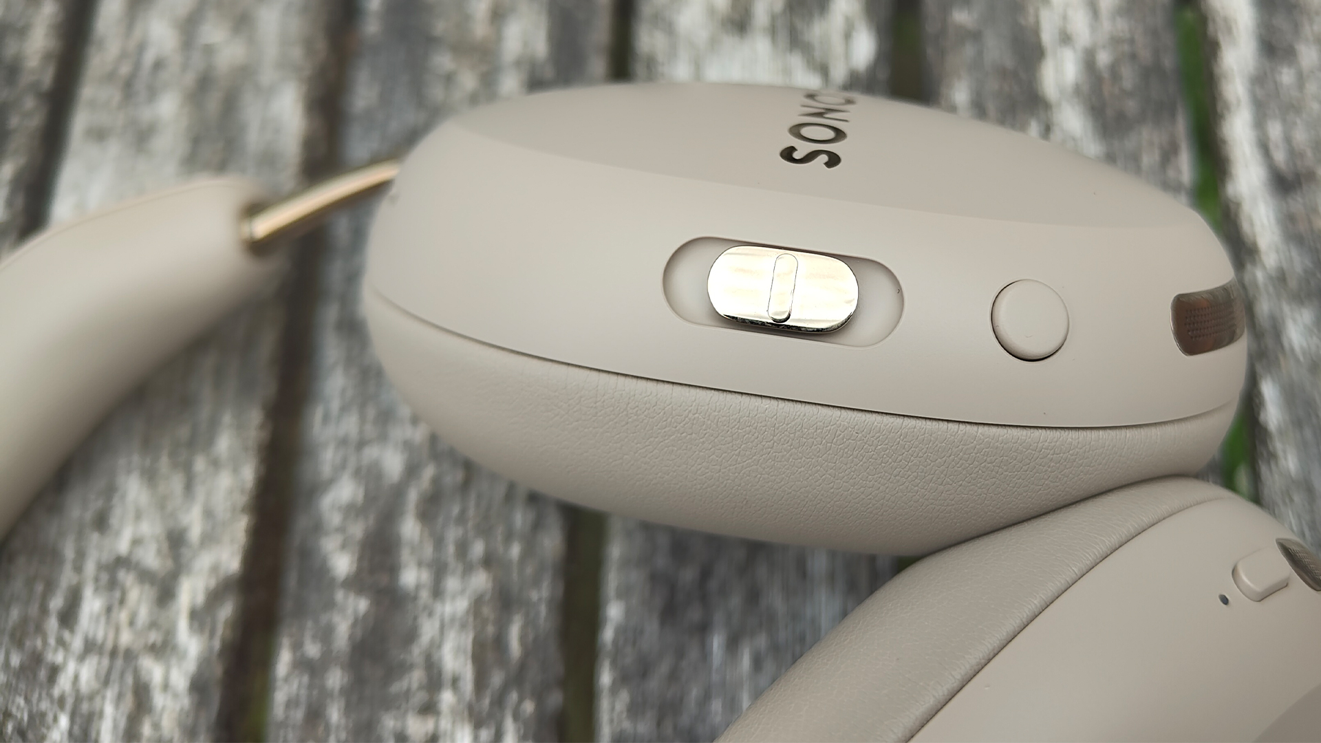 Sonos Ace Ultra wireless headphones close up on side of left earcup showing controls