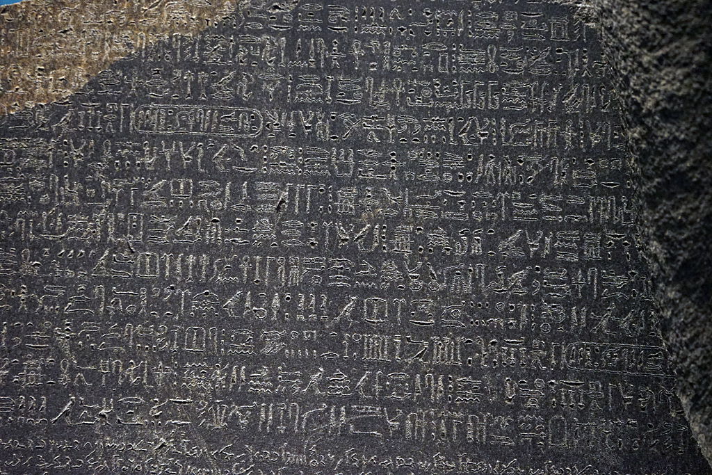 The Ancient Rosetta Stone with Egyptian hieroglyphics