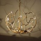 golden coloured hanging light with cream background