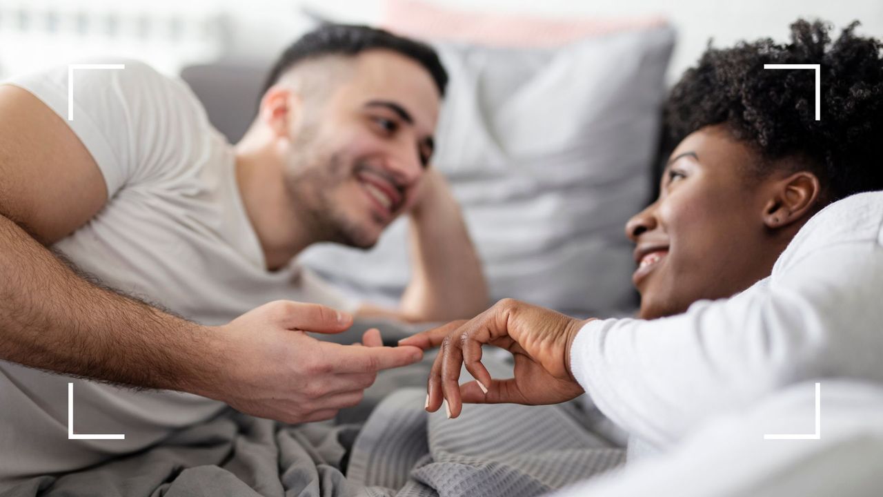 Man and woman in bed holding hands, looking into each other&#039;s eye, representing the magic mountain sex position