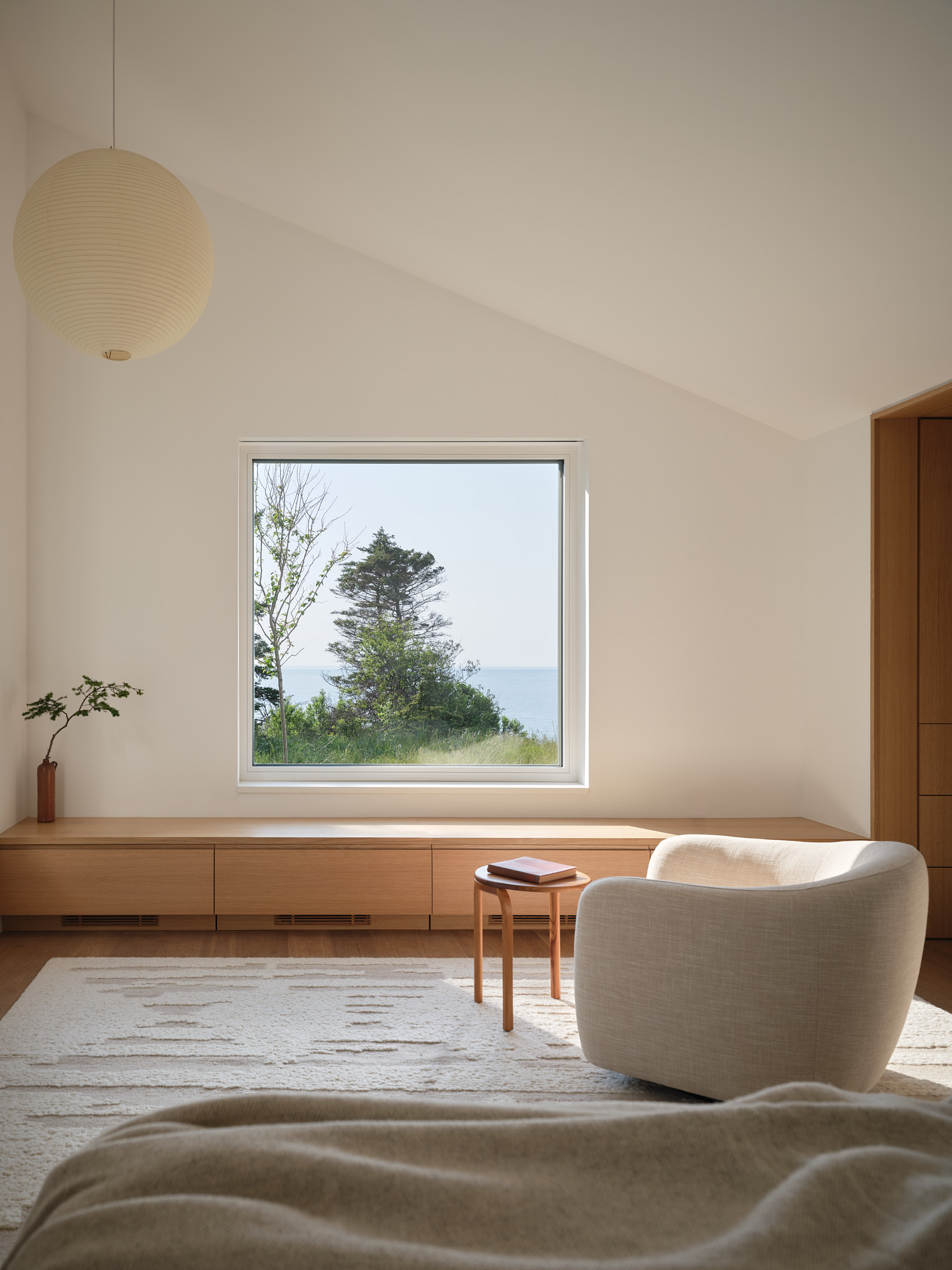 place of work's house in a meadow between the forest and the sea, an architectural, geometric house in leafy countryside