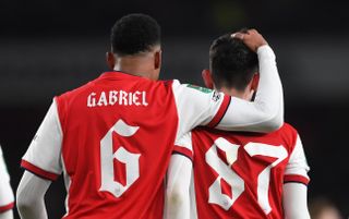 Charlie Patino is congratulated on scoring Arsenal 5th goal with Gabriel Magalhaes during the Carabao Cup Quarter Final match between Arsenal and Sunderland at Emirates Stadium on December 21, 2021 in London, England.