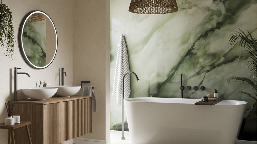 green and white marble effect wall panels in bathroom with freestanding white bath and wooden wall mounted vanity unit with two sinks