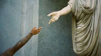 Suzannah Pettigrew image of man reaching out to statue