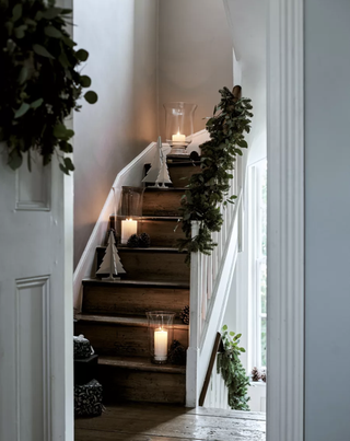 A decorated wood staircase decorated for Christmas