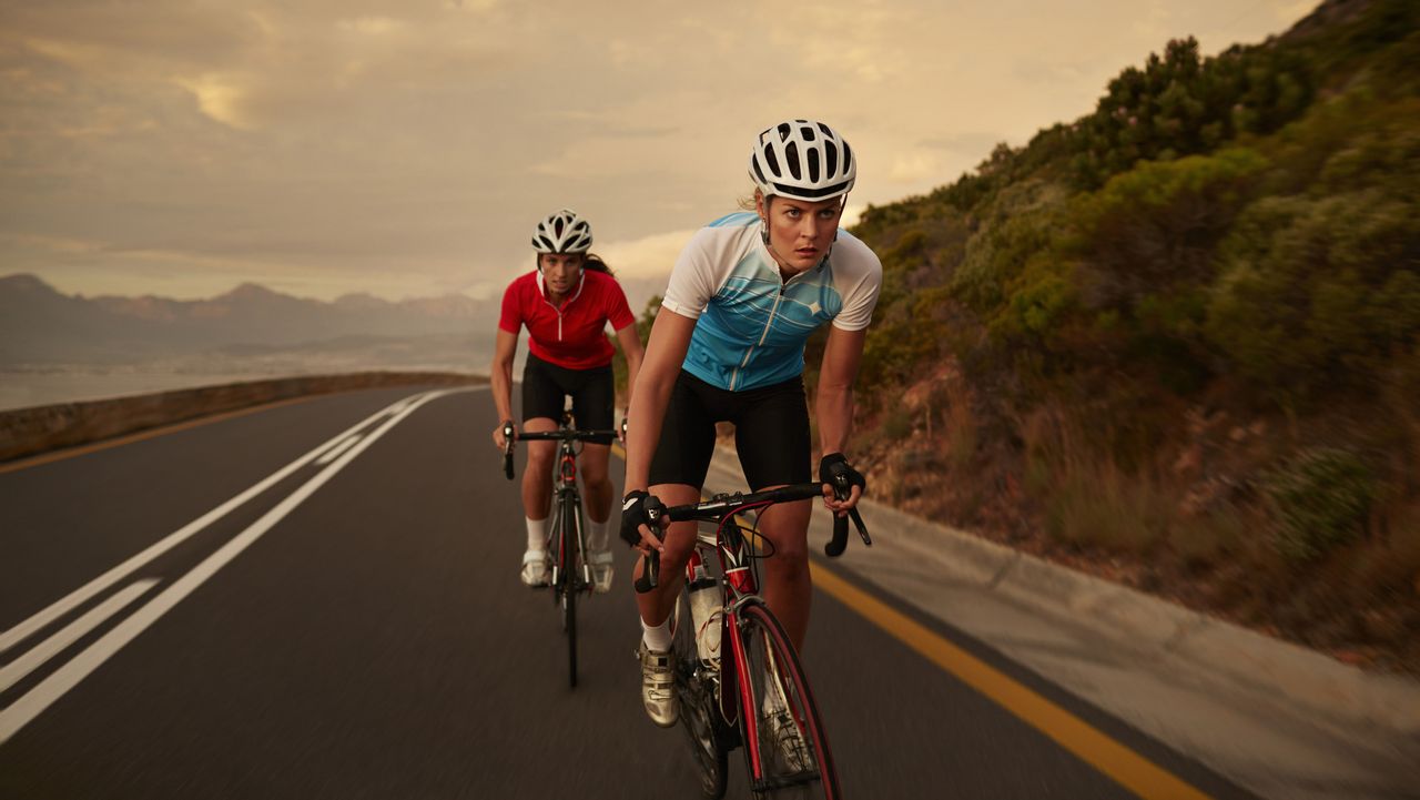 Supercharge your cycle: women battle up a killer hill on their bikes