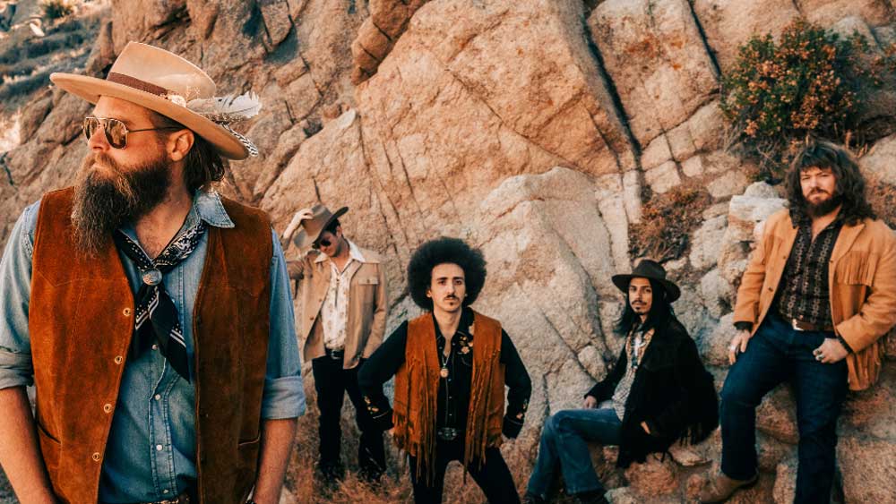 Robert Jon &amp; The Wreck posing in a canyon