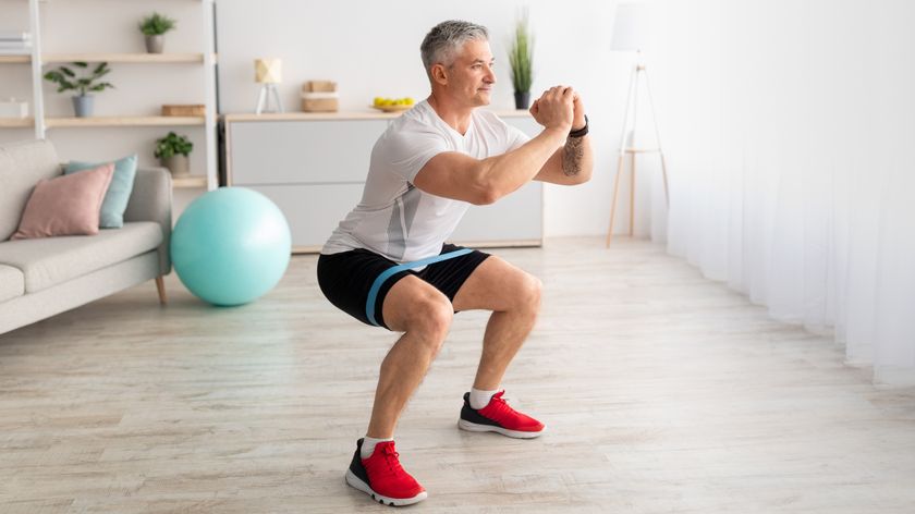 a man doing a resistance band squat