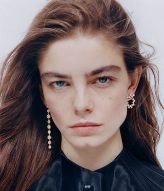 Model wears two different earrings