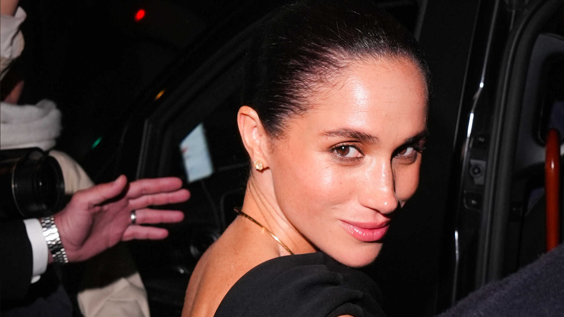 Meghan Markle wearing a black dress