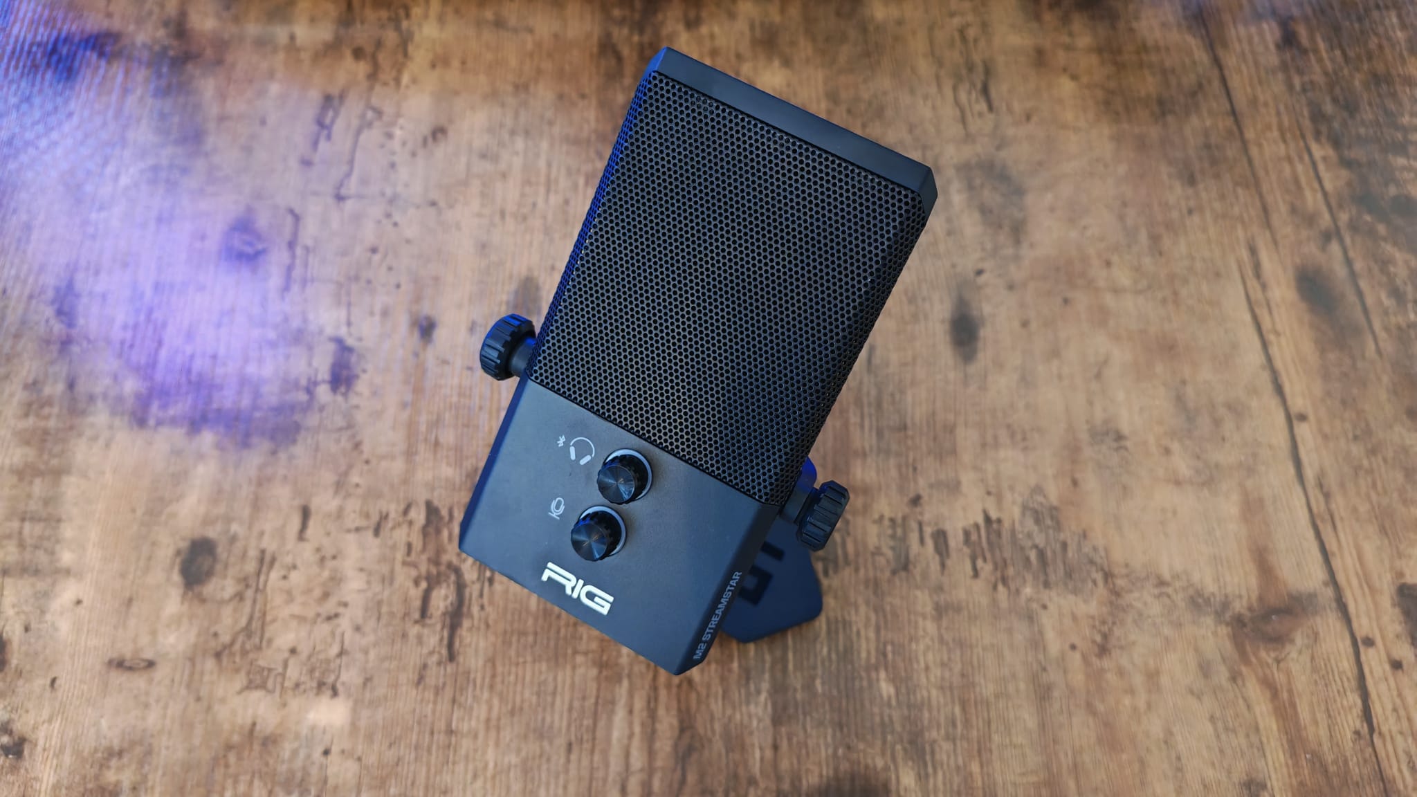 The RIG M2 Pro HD Streamstar pointing up while sitting on a gaming desk