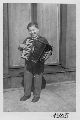 Pictured: Daniel Libeskind playing his accordion in Łódź, Poland, 1955, aged nine