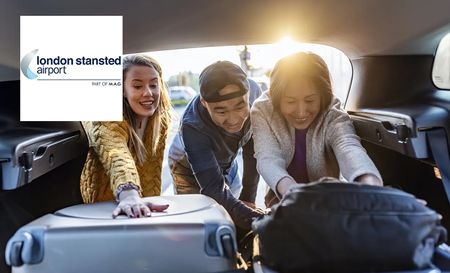Family of three loading their luggage in the boot at stansted airport parking