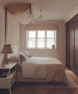 bedroom in neutral colours with fabric drape headboard
