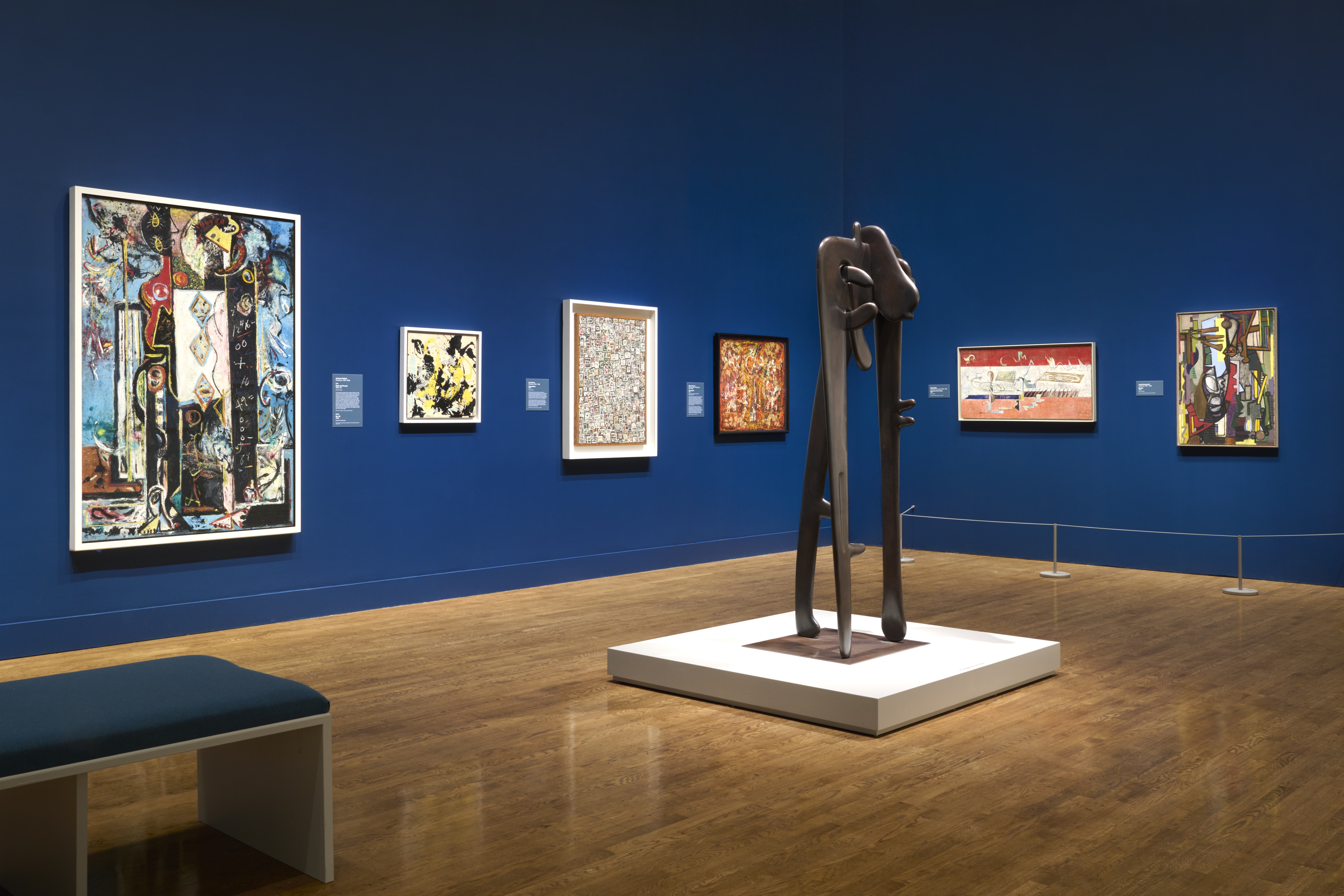 bronze sculpture in blue exhibition space