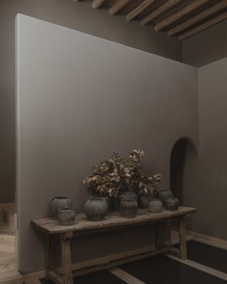 A space with dark grey walls and wooden elements