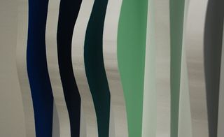 Vertical wavy blue, black and green lines.