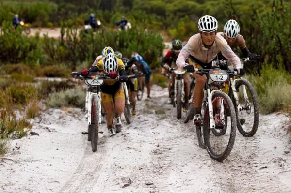 Burry Stander riders a sandy climb that others push during stage 5 of the 2012 Absa Cape Epic Mountain Bike stage race from the Overberg Primary &amp; High School in Caledon to Oak Valley Wine Estate in the Elgin Valley, South Africa on the 30 March 2012