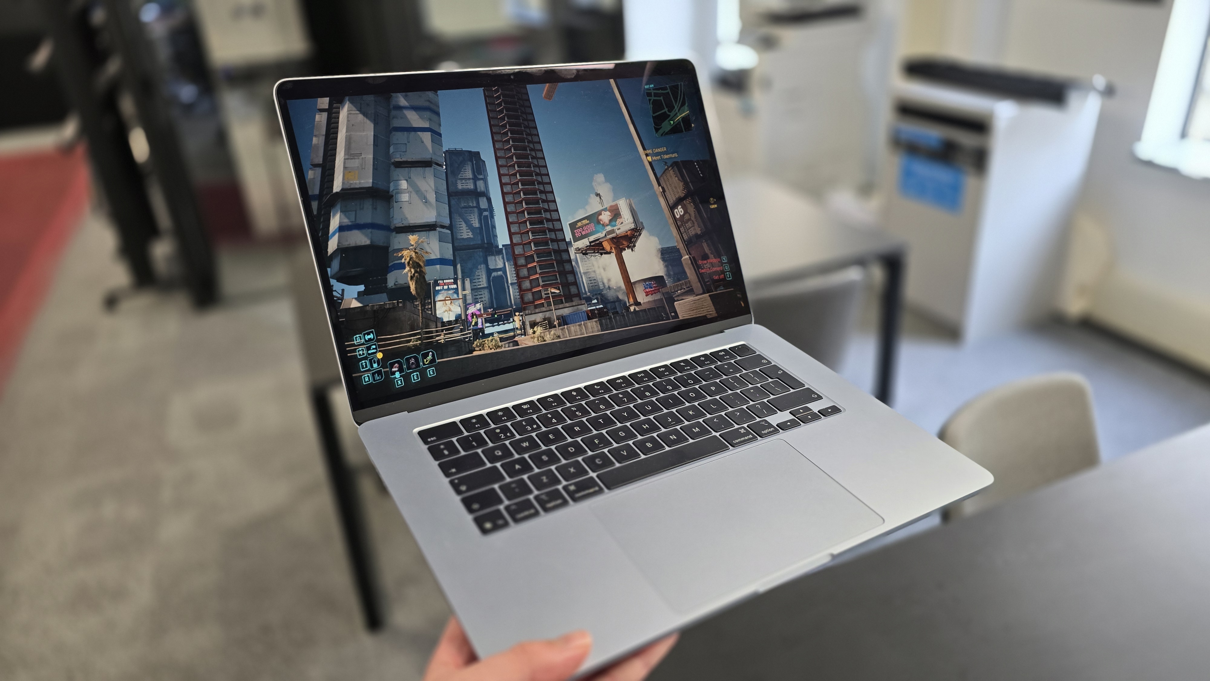 Cyberpunk 2077 on a MacBook in an office