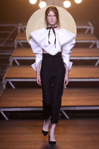 A Jacquemus model wearing a large straw sunhat on the jacquemus runway