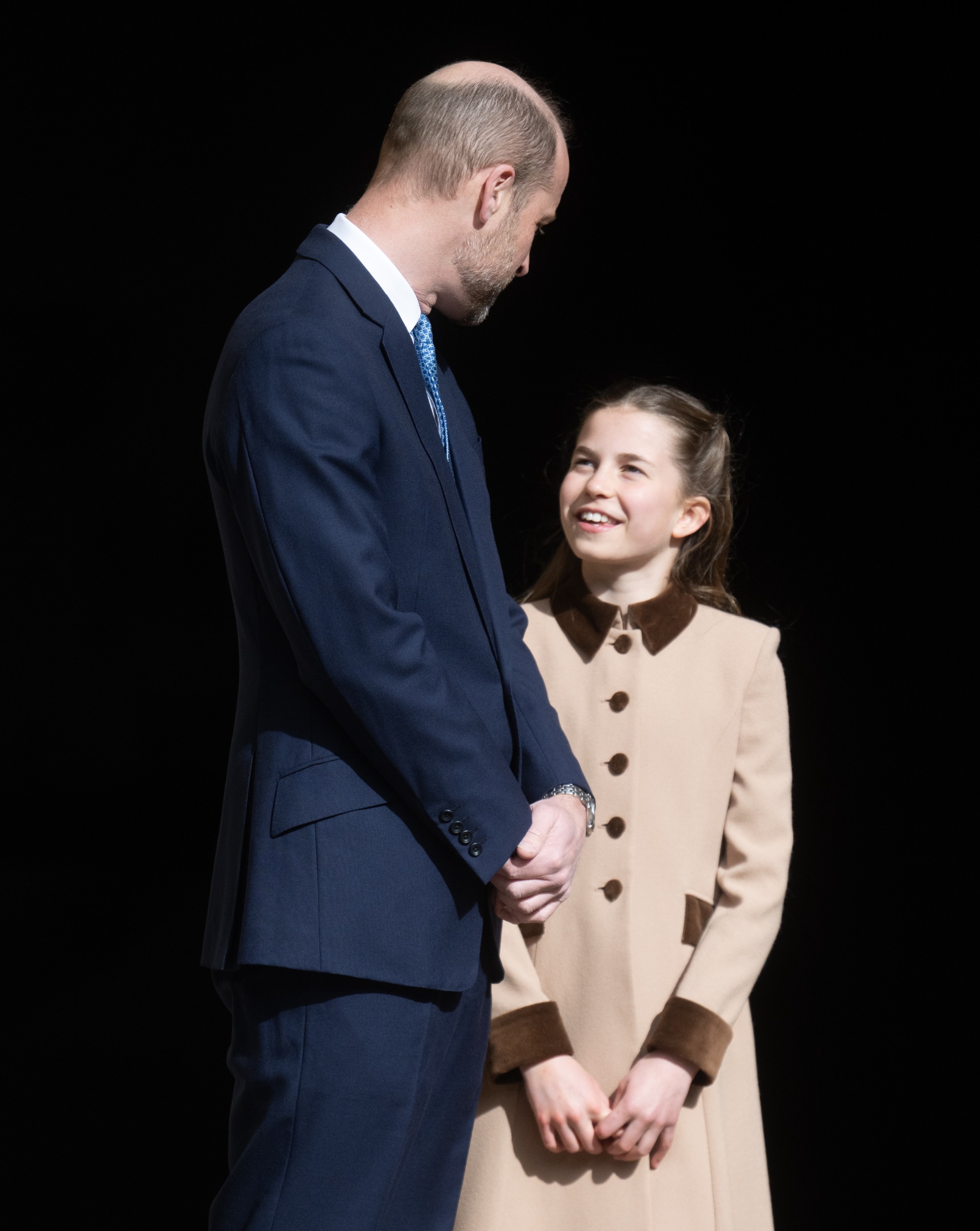Princess Charlotte smiling at Prince William