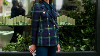 woman in blue and green check blazer