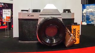 Giant Pentax K1000 camera, with giant roll of Kodak 400 film, on display at The Photography & Video Show 2022