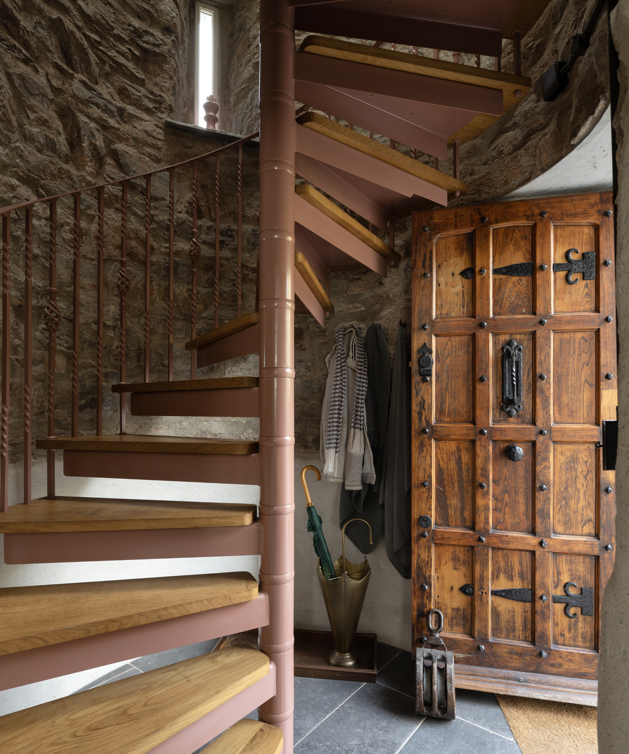spiral staircase with stone wall