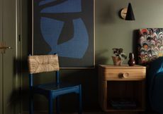 Olive green bedroom with blue and black canvas