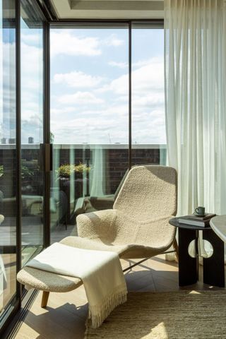 101 on Cleveland penthouse by Bergman & Mar focusses on a curved brown recline chair with a side table.