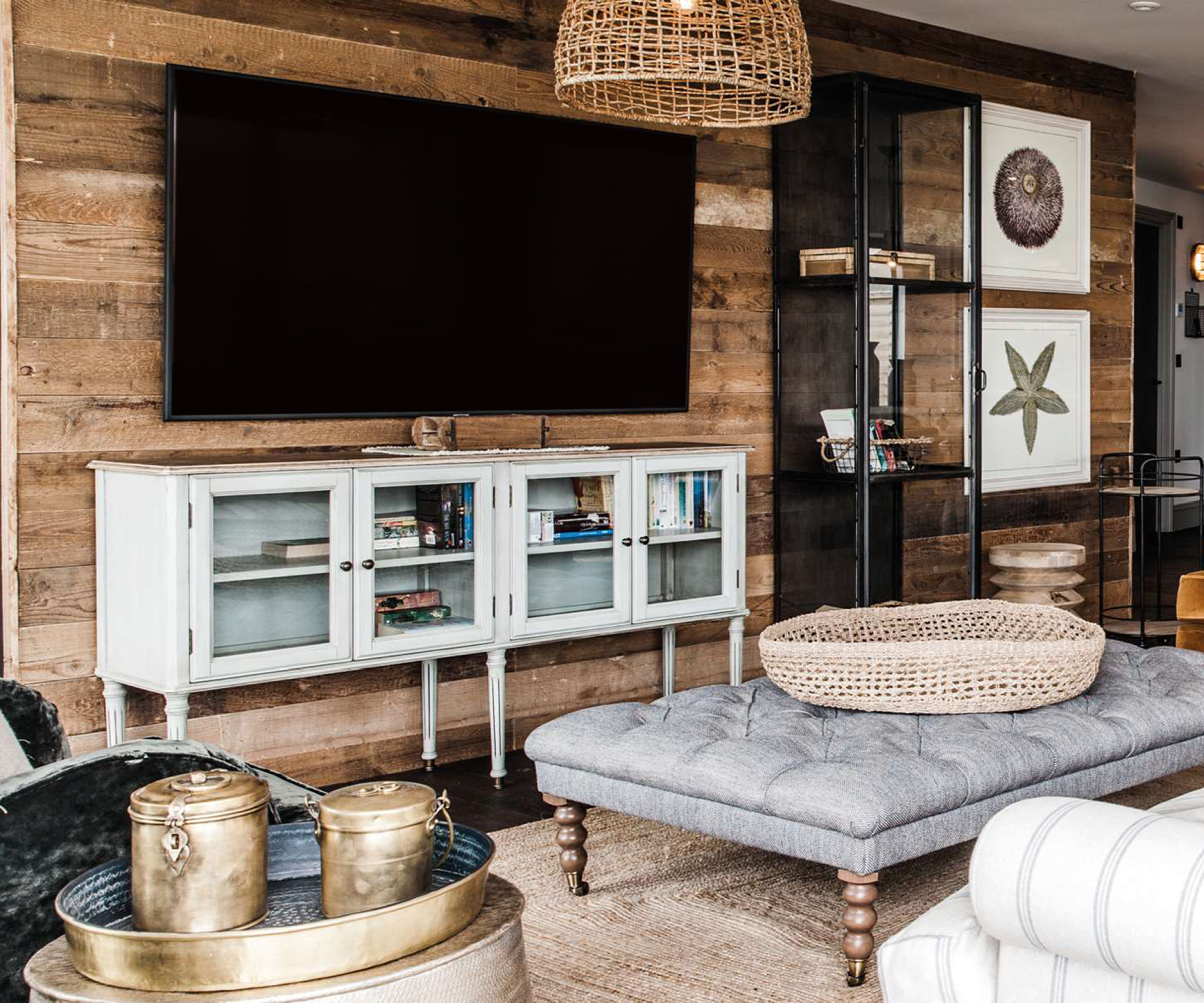 rustic living room with timber clad wall, wooden furniture and dark wooden floor