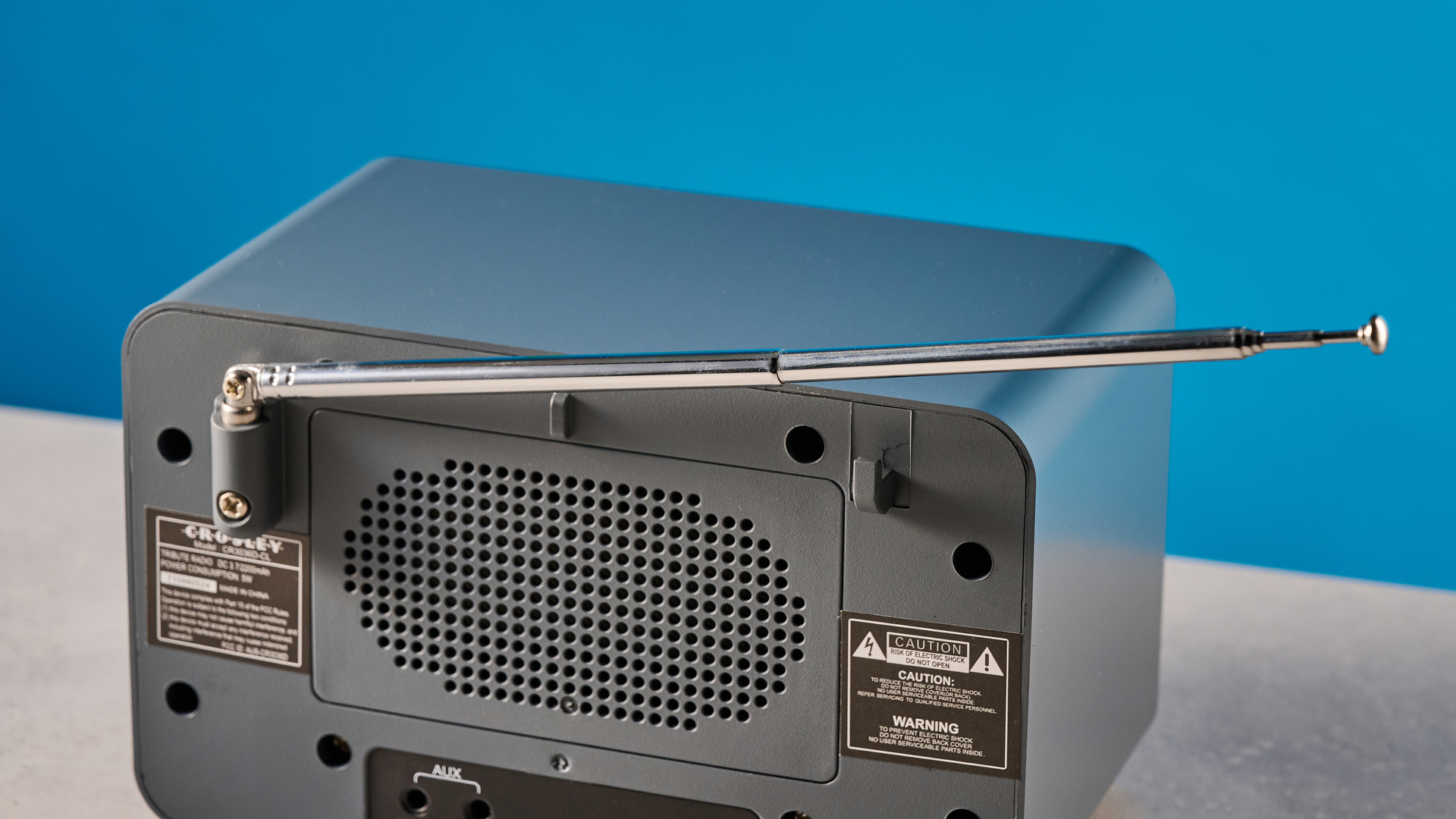 Crosley Tribute Radio in gray color photographed on a blue background