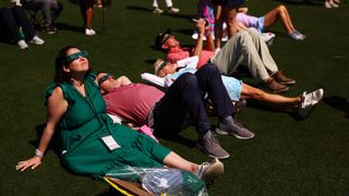 Masters patrons watch the solar eclipse