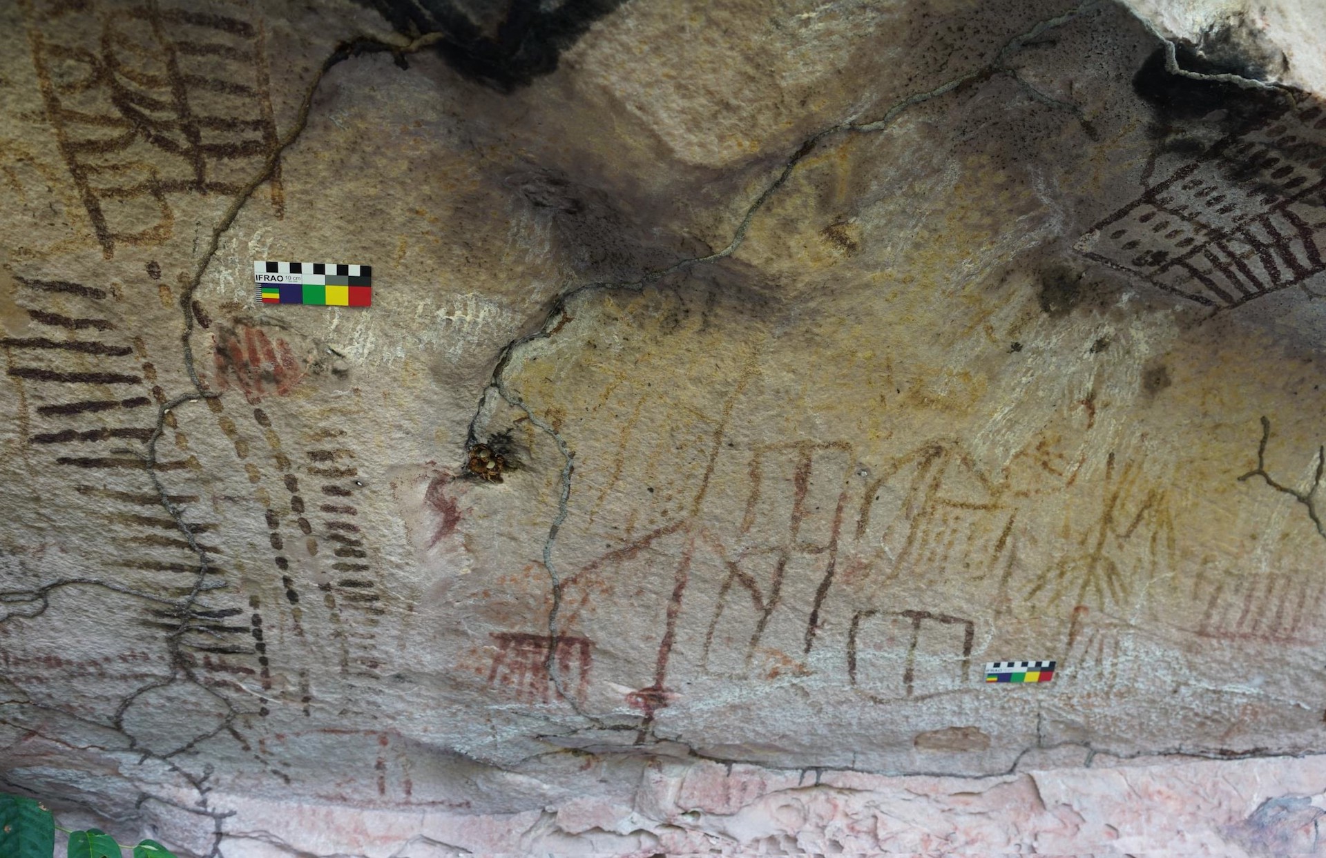 A view of the rock art showing parallel lines and squares with dots inside