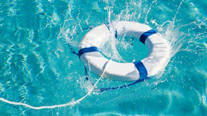 blue and white life ring in swimming pool