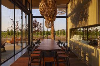 Table and chairs beneath hanging artwork at Caymus-Suisun Winery in California