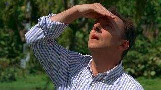 Michael Emerson as Ben in Lost, looking up and shading his eyes