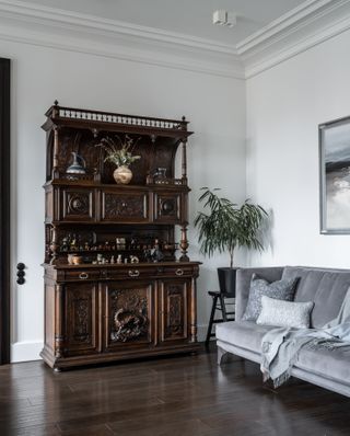 A gray sofa with cushions and a throw in a modern home