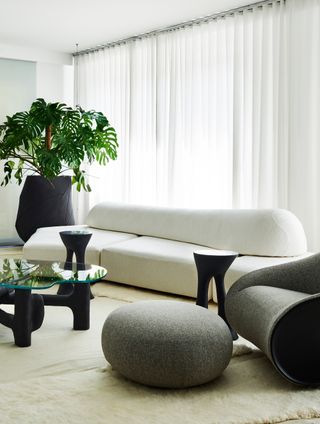 a neutral living room with a modern edra sofa and a rug shag rug