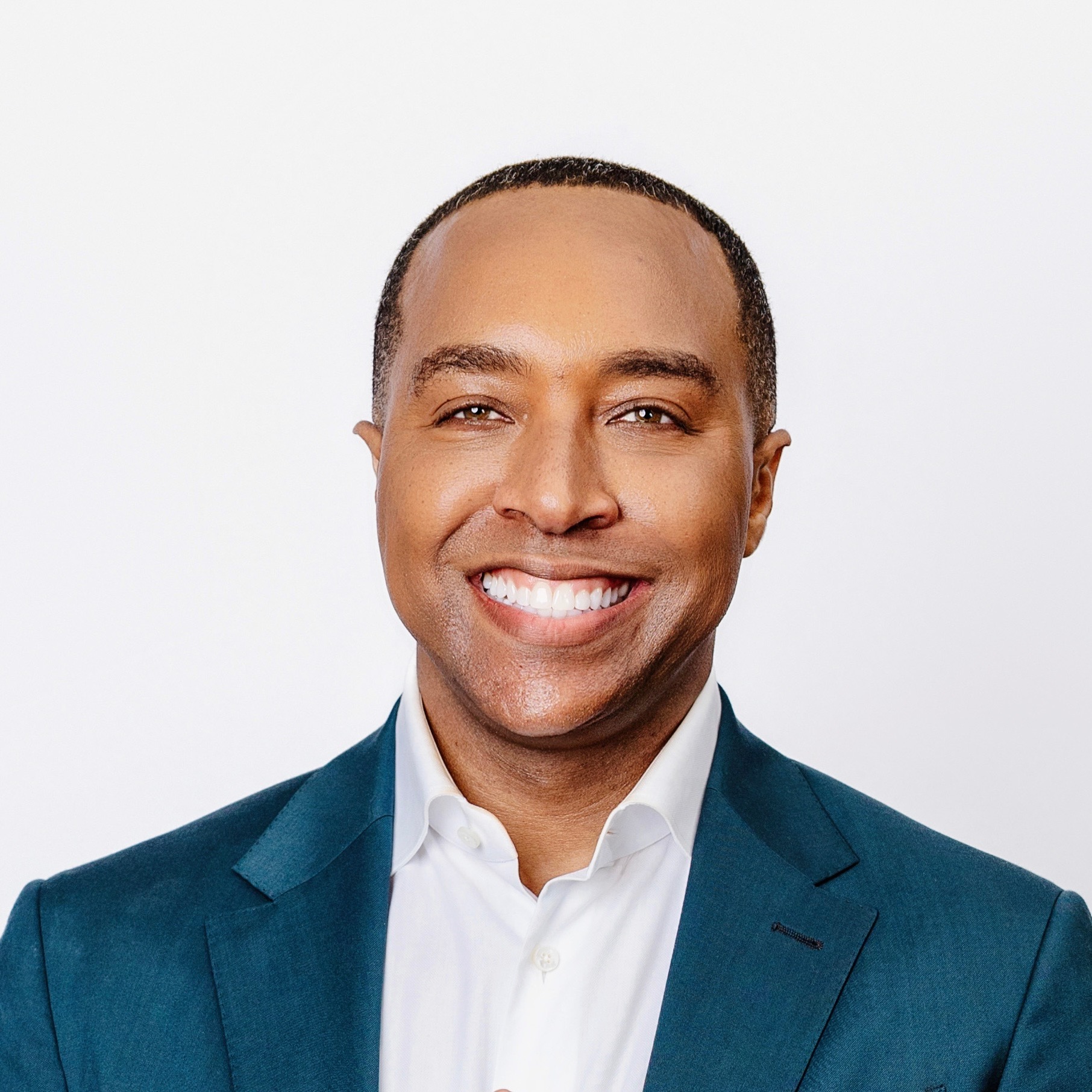 Dr. Corey L. Hartman in a blue suit and white shirt