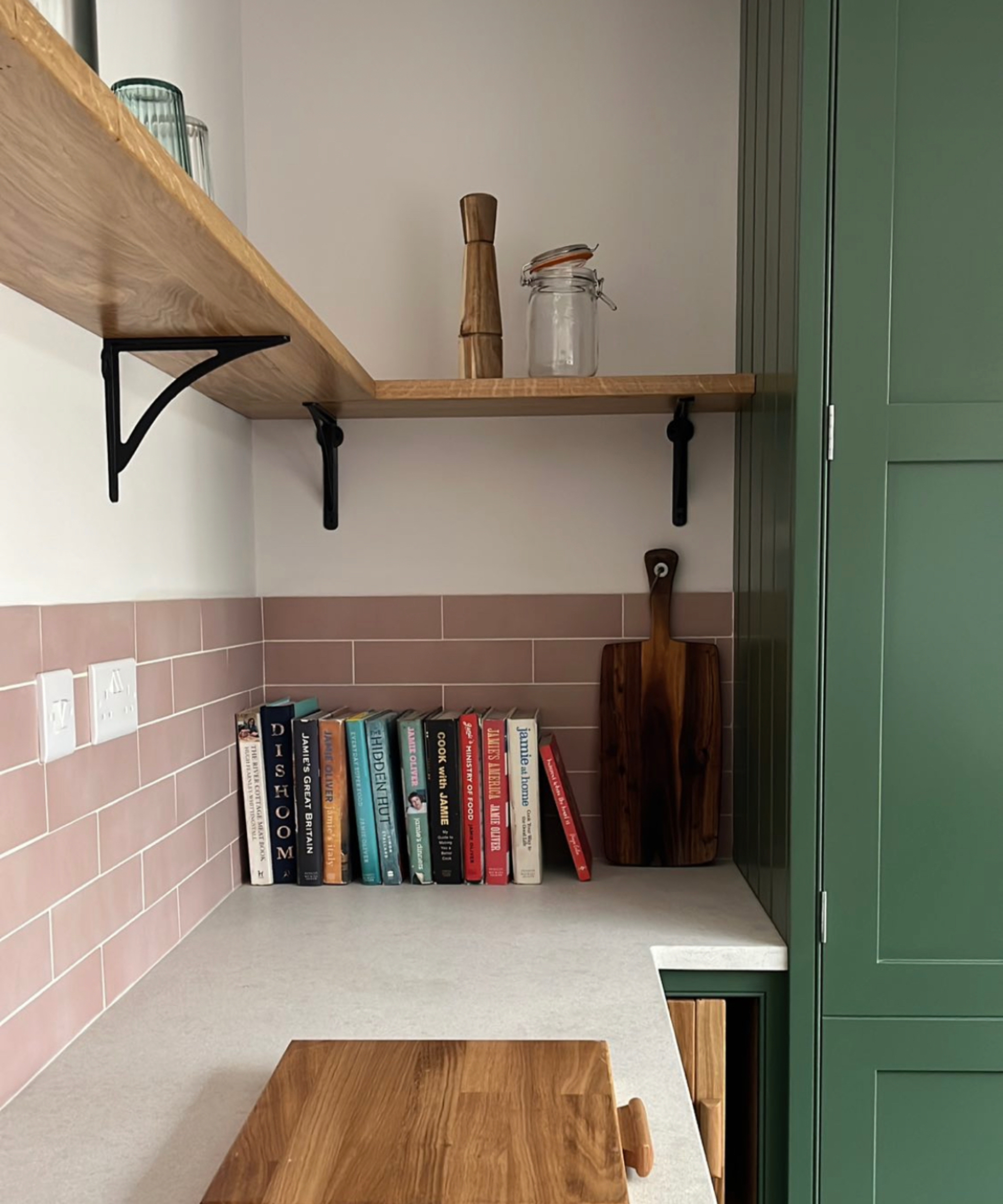 wooden shelving running along wall and to side return